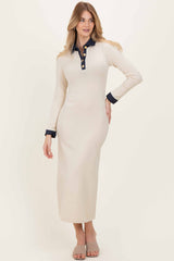 woman wearing an ivory long sleeve maxi dress with a navy collar and button placket, styled with nude heeled sandals