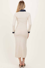 woman wearing a cream-colored long sleeve midi dress with a navy blue collar and back view visible