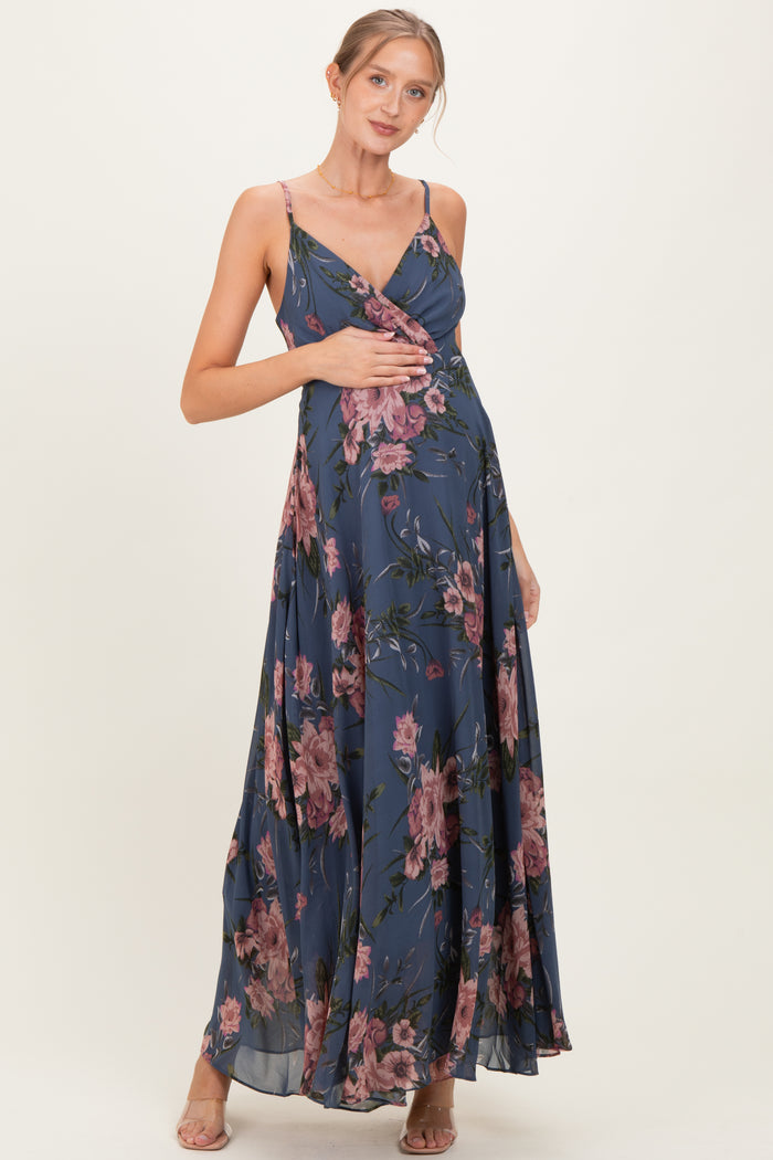 woman wearing a navy floral maternity maxi dress and holding her baby bump