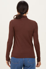 woman wearing a fitted brown long sleeve top with a mock neck and styled hair in a ponytail, viewed from the back