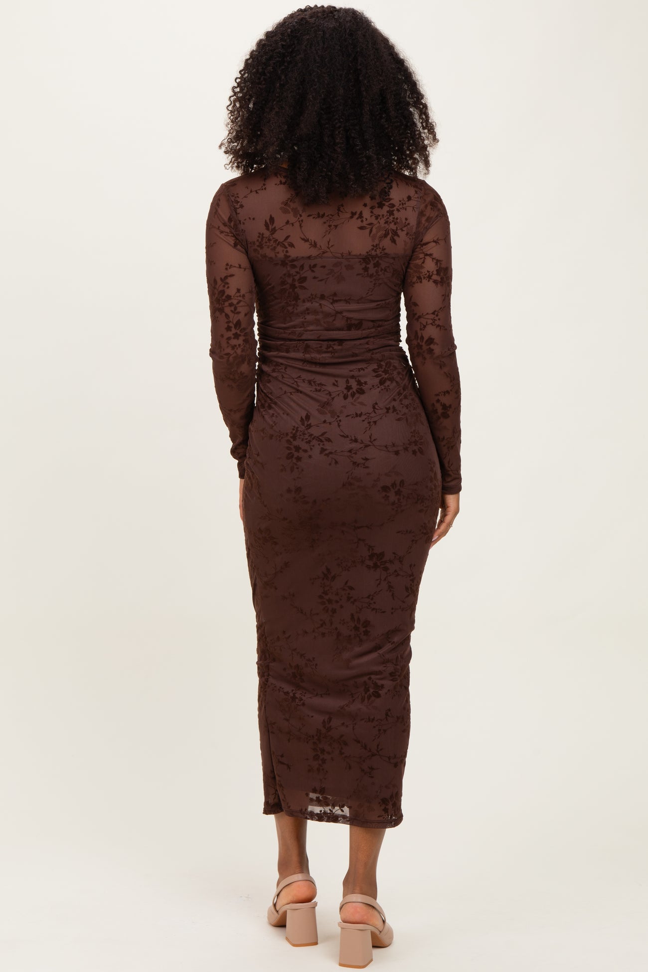 woman wearing a brown long sleeve floral lace bodycon dress, viewed from the back