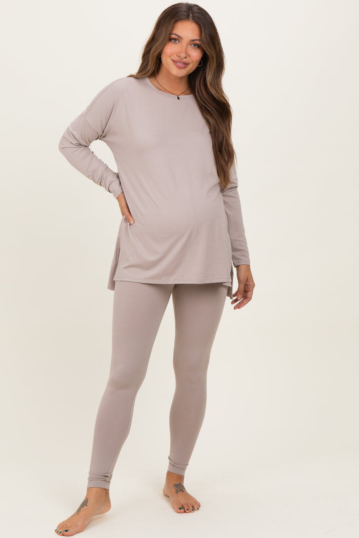 woman wearing a light taupe long sleeve maternity top and matching leggings, showing her baby bump