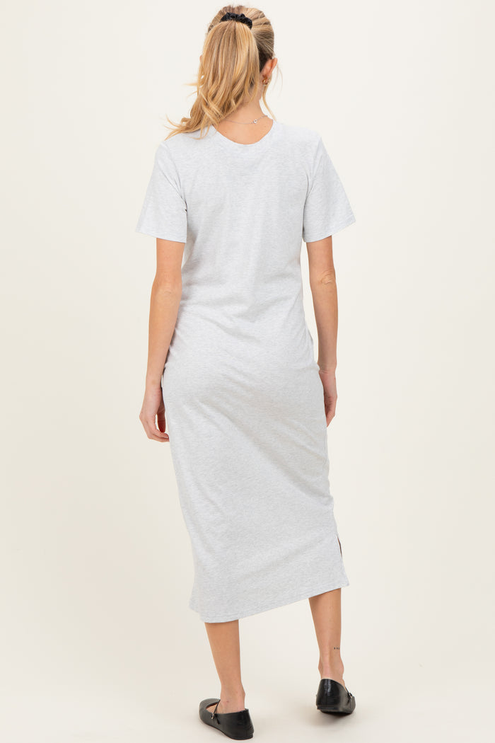 woman wearing a gray short sleeve maternity dress with a side slit, shown from the back