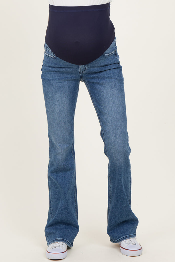 woman wearing blue maternity bootcut jeans with a navy over-the-belly panel