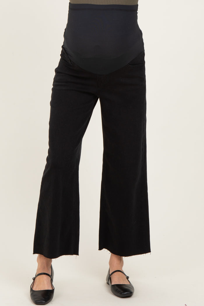woman wearing black wide-leg maternity jeans with a high waist and stretchy panel for comfort