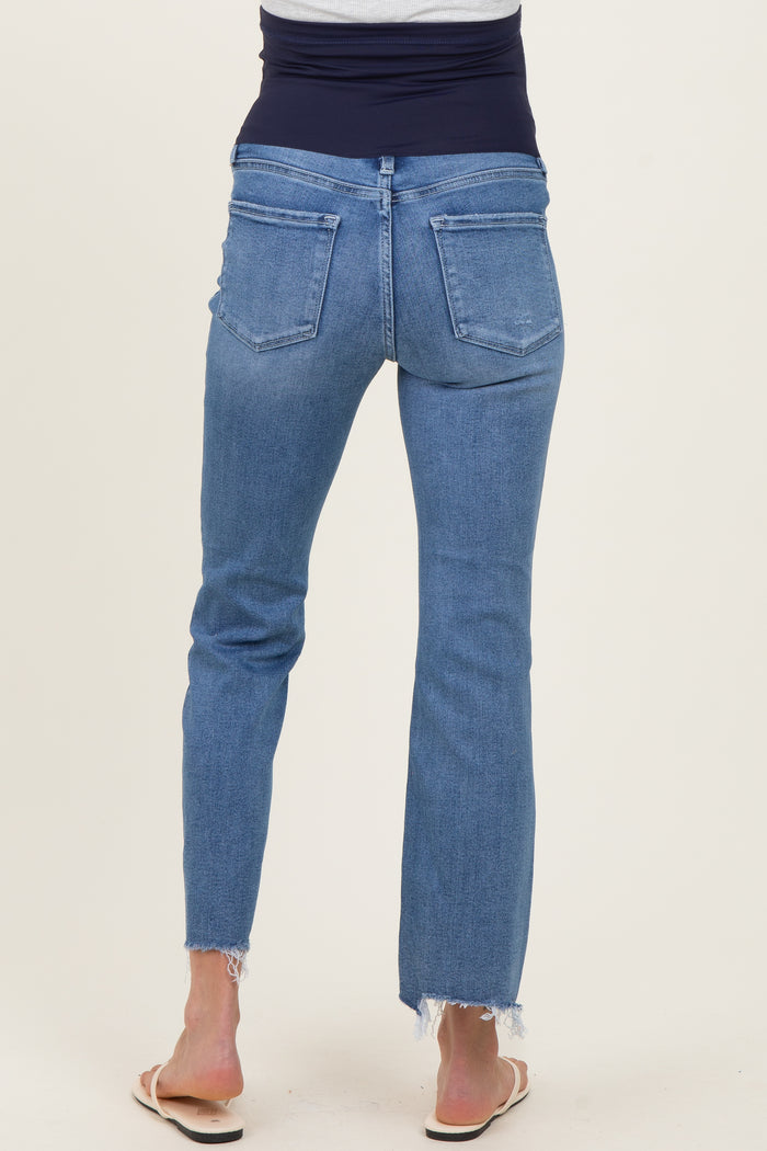 woman wearing light blue maternity jeans with a stretchy black waistband, showing frayed hem at the ankles