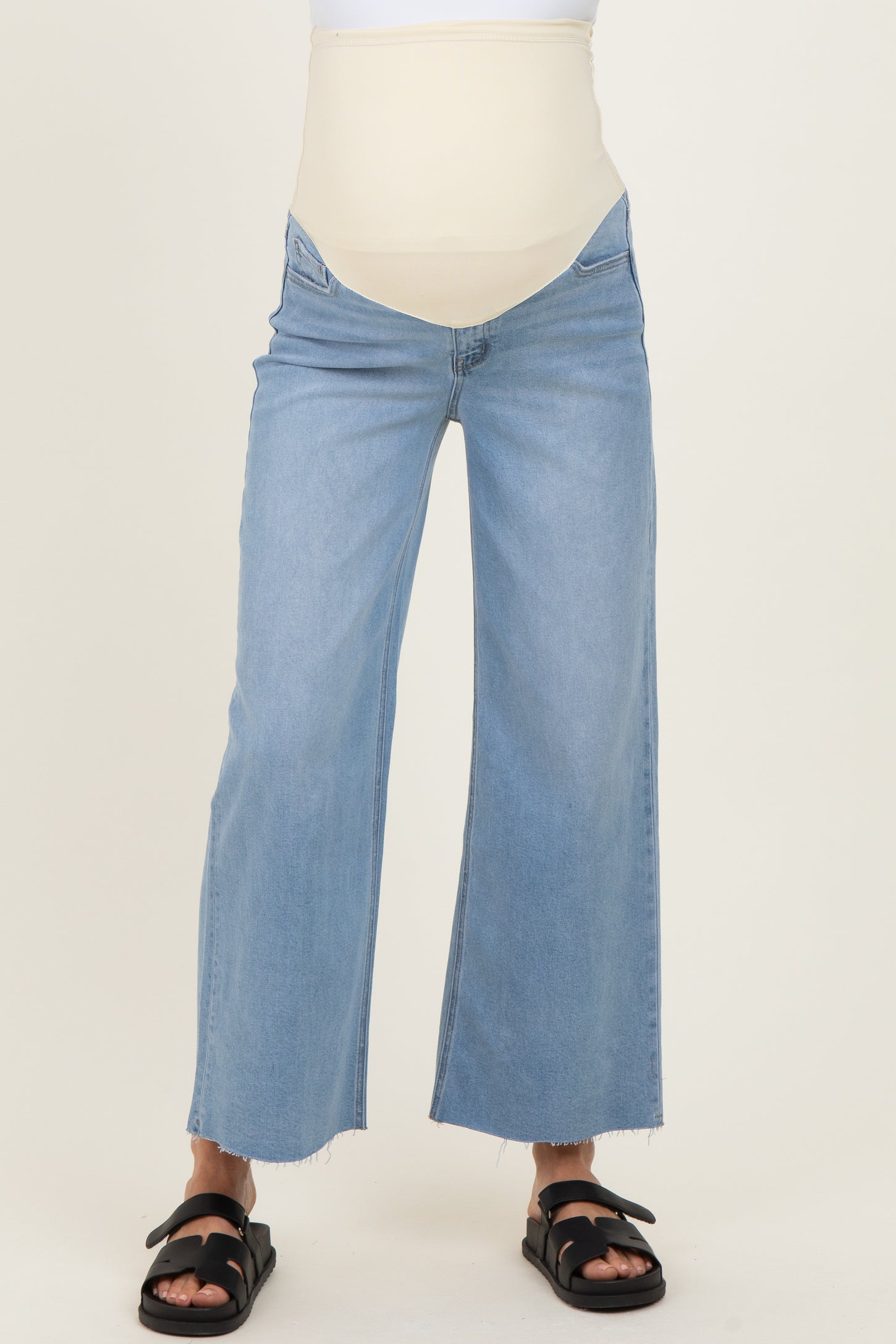 maternity wear light blue wide-leg jeans with a beige belly support panel worn by a model