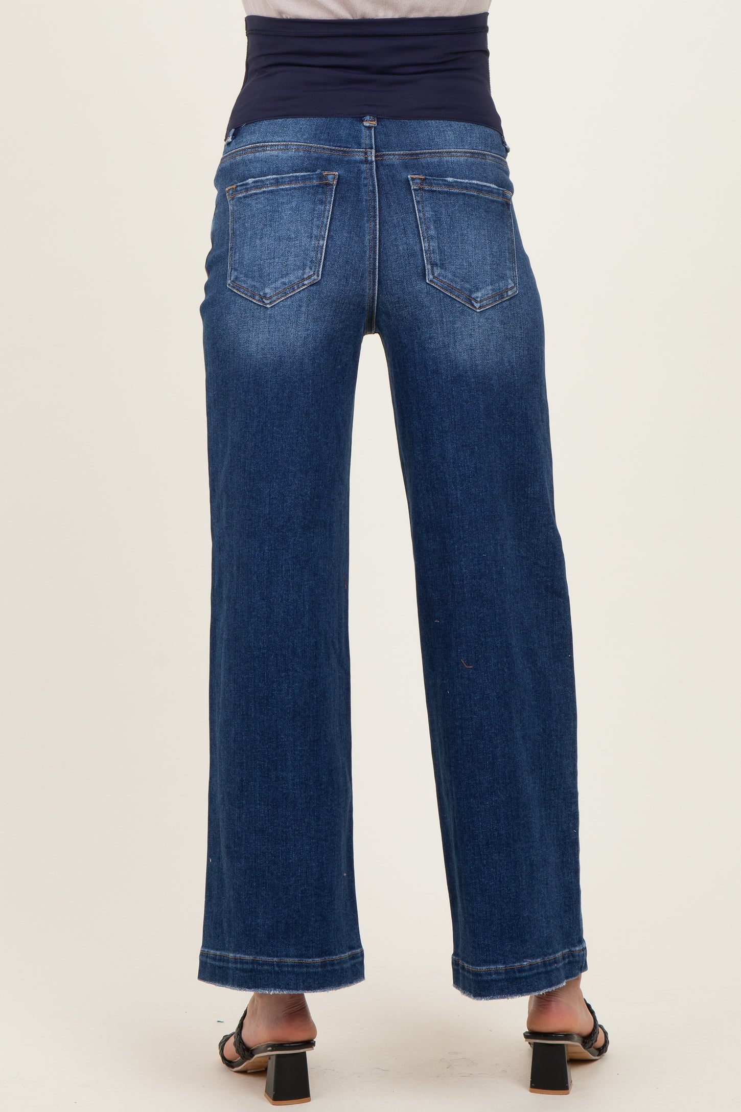 maternity wear wide leg denim jeans with a dark blue waistband, model viewed from the back