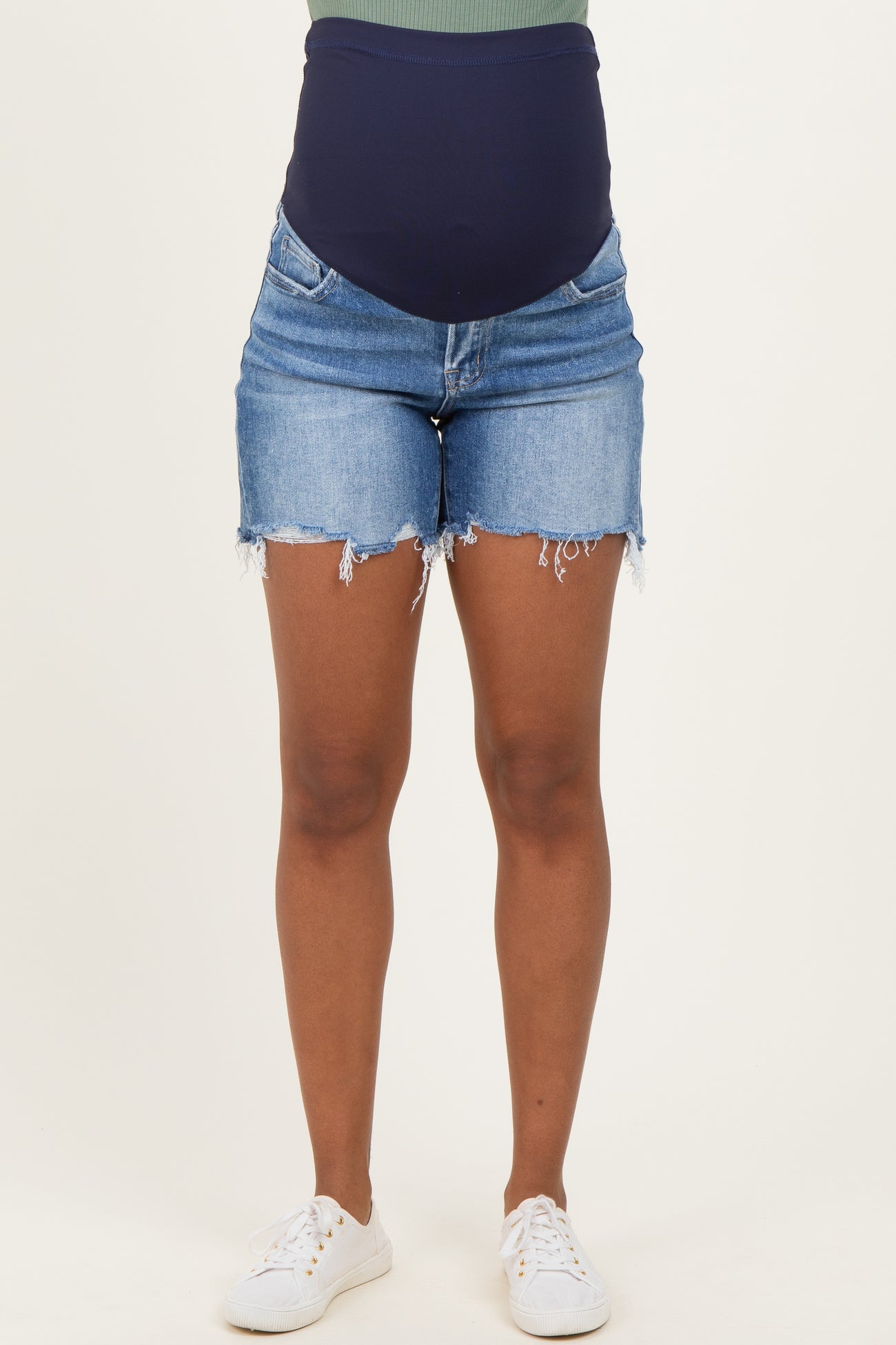 woman wearing maternity denim shorts with a dark blue over-the-bump panel and distressed hems