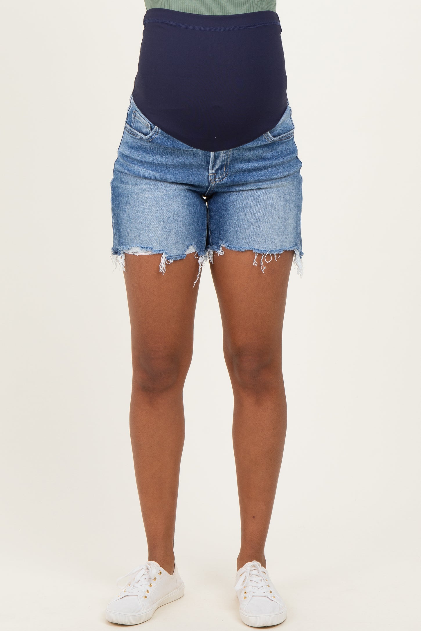 woman wearing maternity denim shorts with a dark blue over-the-bump panel and distressed hems