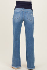 woman wearing light blue maternity jeans with a high waistband and frayed hem, facing away from the camera
