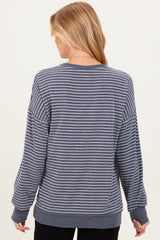 woman wearing a gray and white striped maternity sweatshirt with a relaxed fit and long sleeves