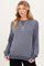 woman wearing a navy and white striped maternity sweatshirt with a relaxed fit and long sleeves, showing her baby bump