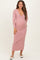 woman wearing a light pink ribbed long sleeve maternity dress with a v-neck and a visible baby bump