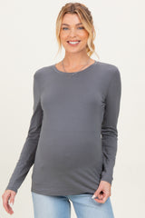 woman wearing a gray long sleeve maternity top and showing her baby bump