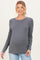 woman wearing a gray long sleeve maternity top and showing her baby bump