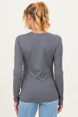 woman wearing a gray long sleeve maternity top viewed from the back