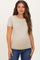 woman wearing a beige short sleeve maternity top and showing her baby bump