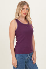 woman wearing a purple sleeveless top with contrast stitching and paired with denim jeans