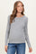 woman wearing a gray long sleeve maternity top with a visible baby bump and paired with blue jeans