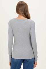 woman wearing a gray long sleeve maternity top with a fitted silhouette and scoop neckline, showing the back view