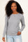 woman wearing a gray long sleeve ribbed top with a relaxed fit and smiling at the camera