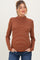 woman wearing a rust striped maternity sweater with a mock neck and a relaxed fit