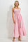 woman wearing a pink smocked tiered maxi dress with spaghetti straps and a flowy silhouette
