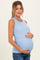 woman wearing a light blue ribbed maternity tank top and holding her baby bump