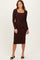 woman wearing a brown long sleeve dress with a square neckline and tie waist detail