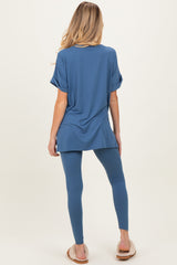 woman wearing a blue oversized maternity top and matching leggings, showing a comfortable and casual look from the back