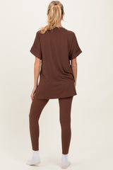 woman wearing a brown maternity top and matching leggings, showing a relaxed fit and soft fabric from the back