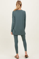 woman wearing a long sleeve green maternity tunic top and matching leggings, seen from the back