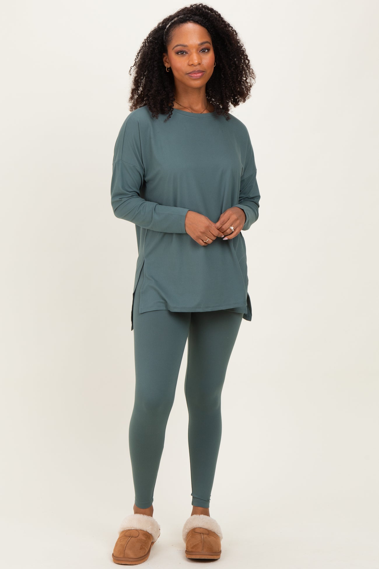woman wearing a teal long sleeve tunic top and matching leggings, styled for a comfortable loungewear look