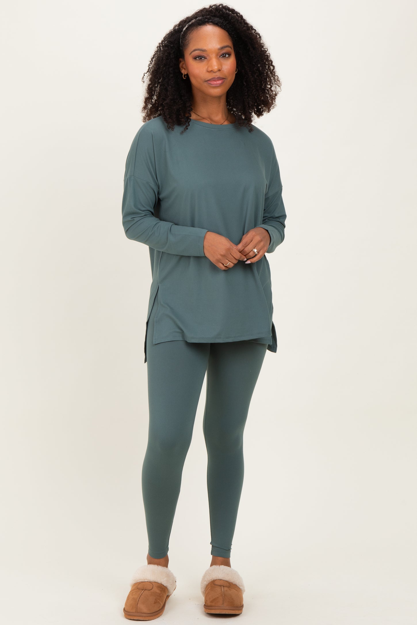 woman wearing a teal long sleeve tunic top and matching leggings, styled for a comfortable loungewear look