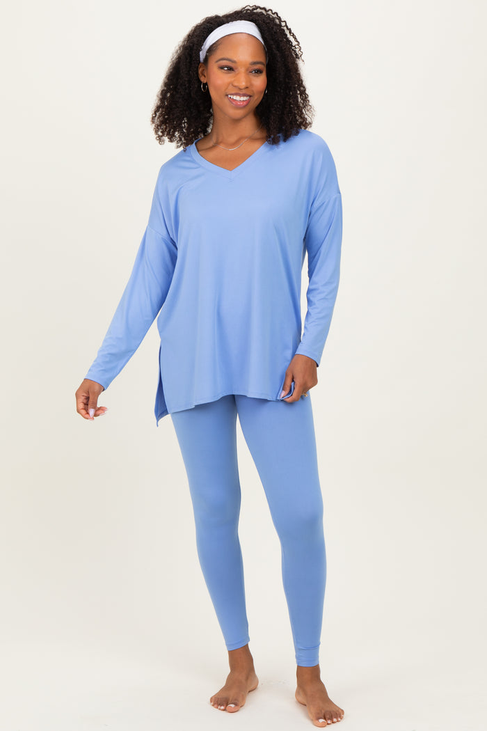 woman wearing a light blue long sleeve top with a v-neck and matching leggings