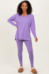 woman wearing a lavender long sleeve tunic top and matching leggings, styled with cozy slippers