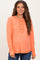 woman wearing an orange maternity long sleeve top with a henley neckline and front buttons, showing her baby bump