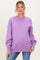 woman wearing a lavender oversized maternity sweatshirt with long sleeves and a relaxed fit, showcasing a baby bump