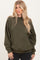 woman wearing an olive green oversized sweatshirt with dropped shoulders and a relaxed fit
