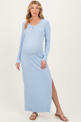 woman wearing a light blue long sleeve ribbed maternity maxi dress with a side slit and showing her baby bump