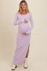 woman wearing a lavender ribbed maternity maxi dress with long sleeves and a side slit, holding her baby bump