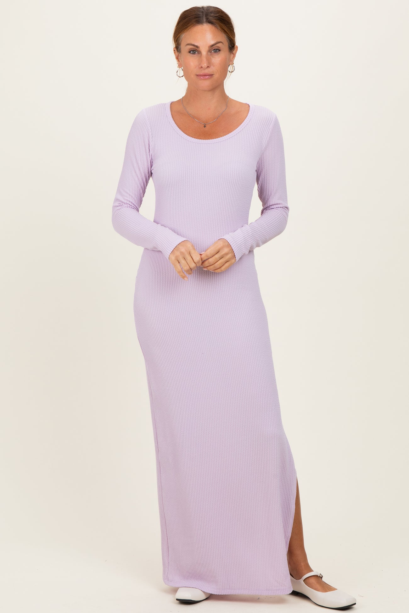 woman wearing a light lavender long sleeve maxi dress with a scoop neck and side slit