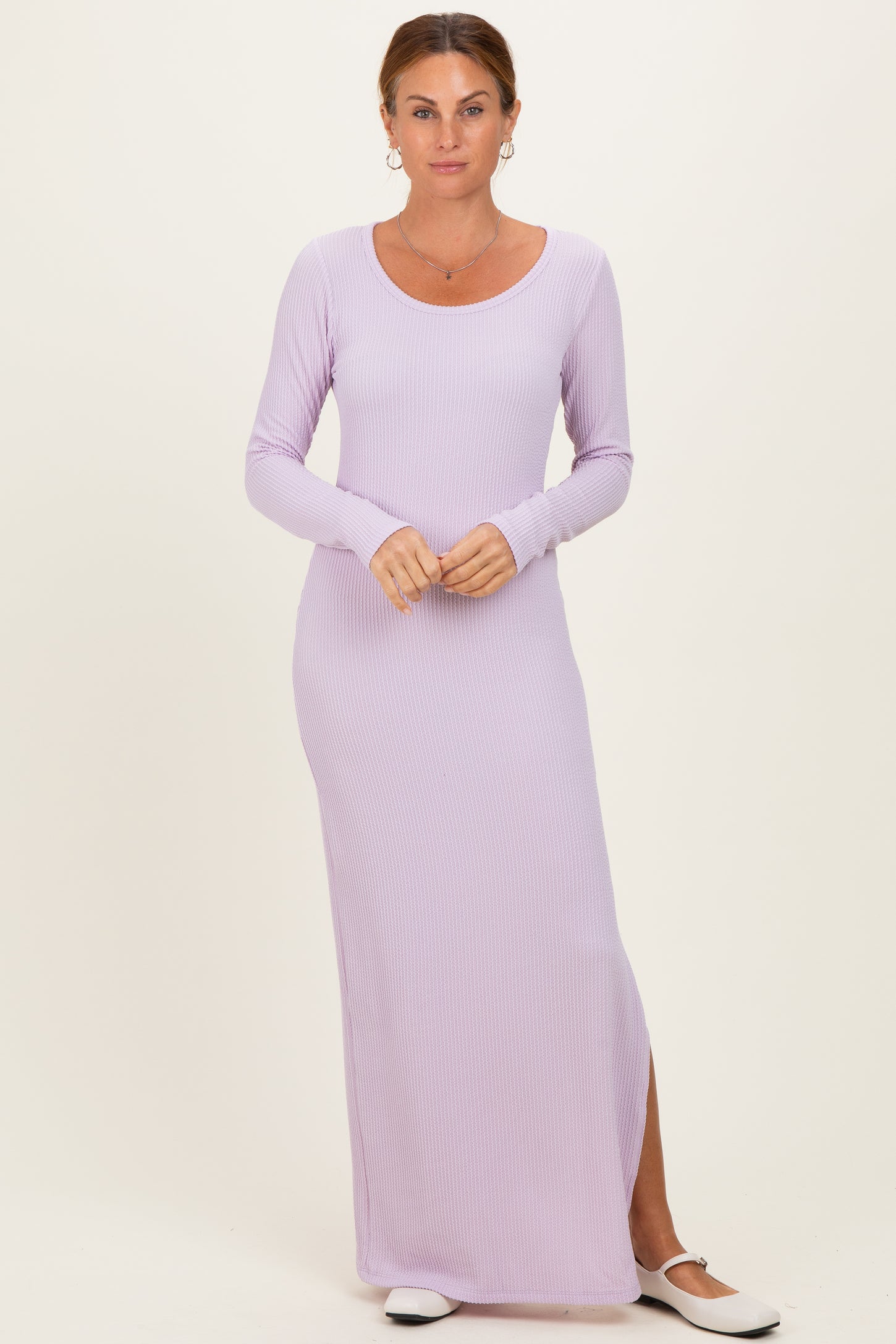 woman wearing a light lavender long sleeve maxi dress with a scoop neck and side slit