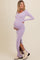 woman wearing a lavender ribbed maternity dress with side slits and a visible baby bump