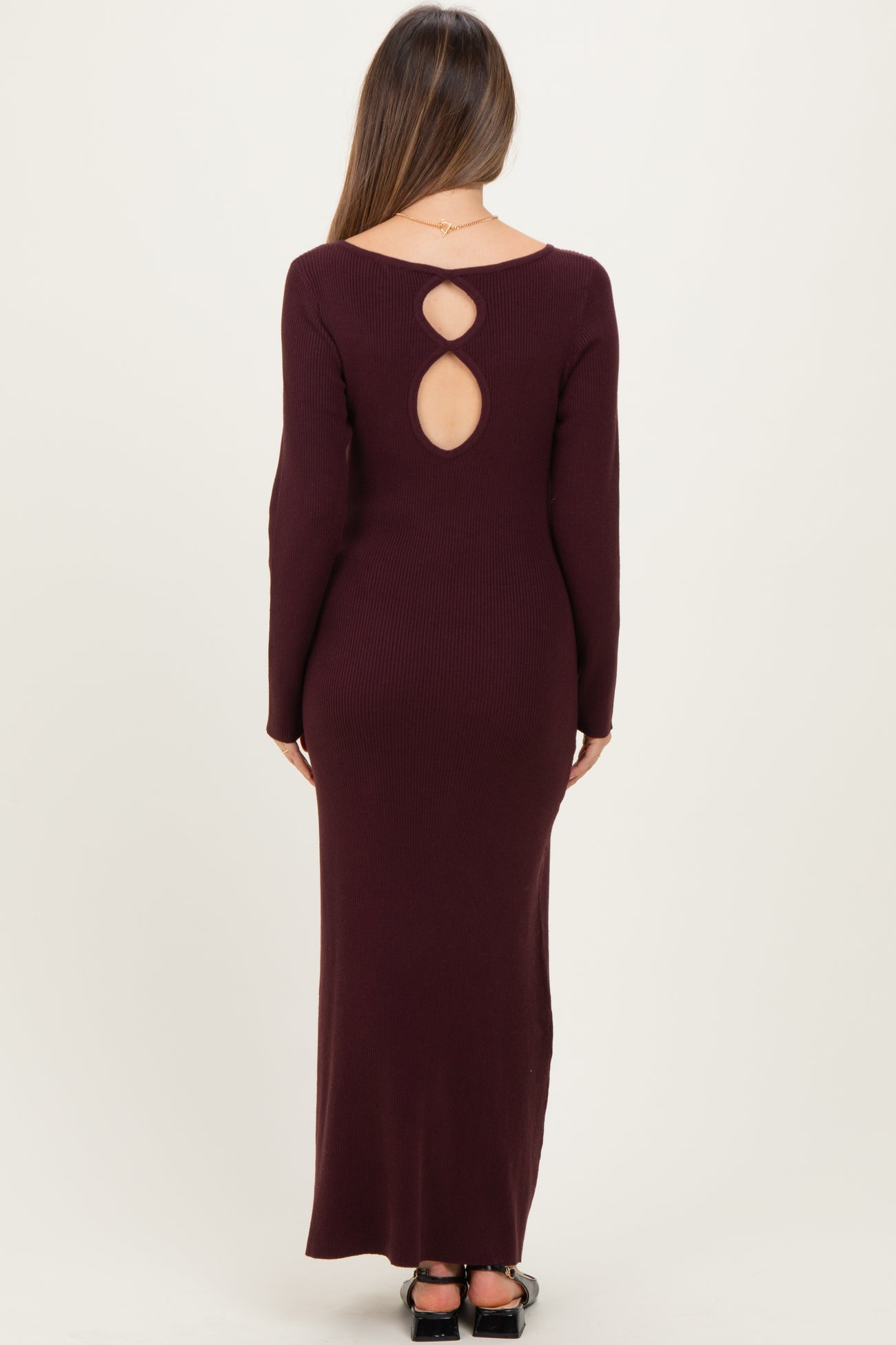 woman wearing a burgundy ribbed maternity maxi dress with a keyhole back detail