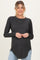 woman wearing a dark grey long sleeve maternity top with a curved hem and a visible baby bump
