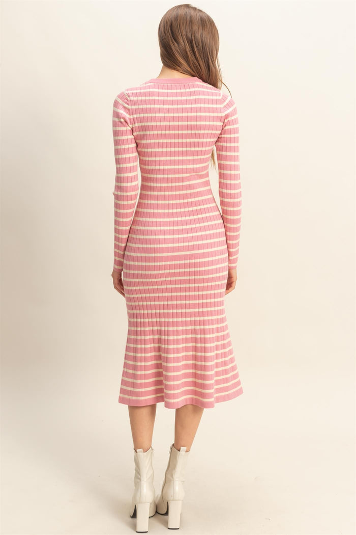 woman wearing a pink and white striped long sleeve ribbed dress with a flared hem and fitted silhouette