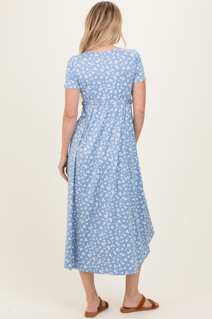 woman wearing a light blue short sleeve maxi dress with a floral pattern and a relaxed fit, seen from the back