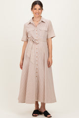 woman wearing a beige striped maternity dress with short sleeves, button front, and a waist tie